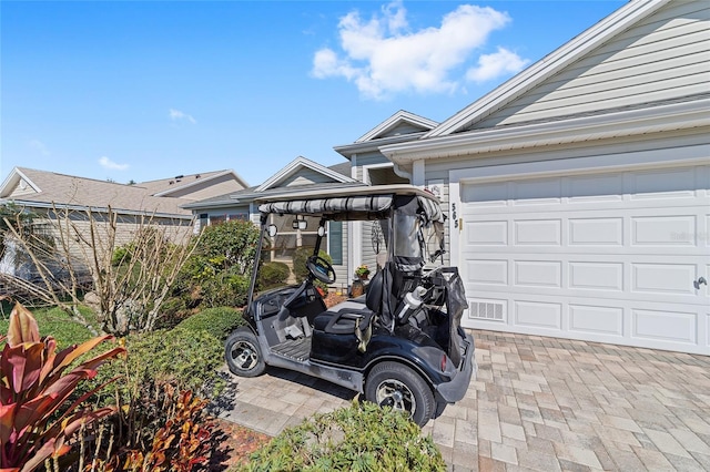 view of front of property featuring decorative driveway and an attached garage