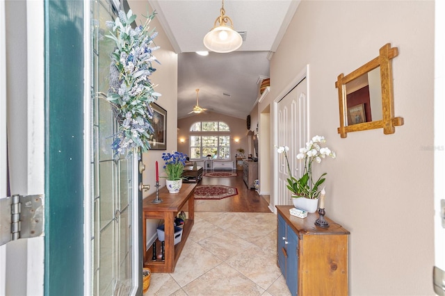 entryway featuring lofted ceiling and light tile patterned flooring