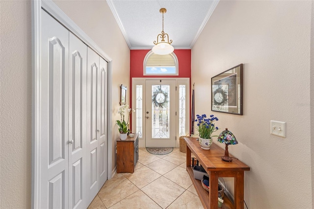 entrance foyer with ornamental molding and light tile patterned flooring