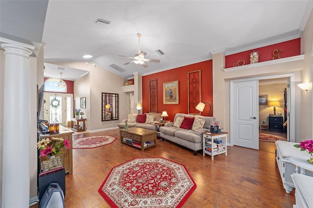 living room featuring decorative columns, visible vents, lofted ceiling, ornamental molding, and wood finished floors