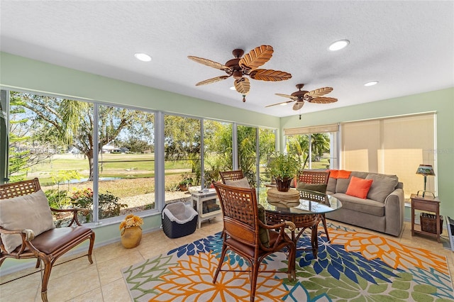 sunroom featuring a ceiling fan