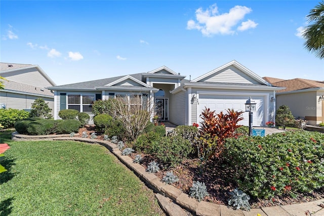 single story home with a front yard and an attached garage