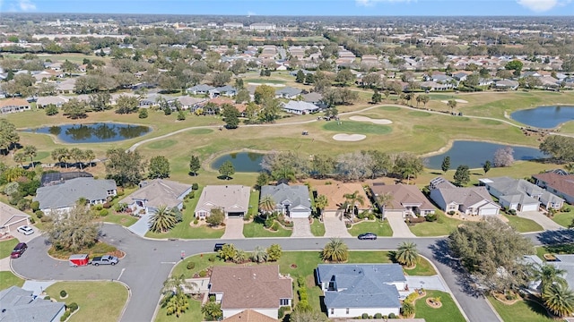 birds eye view of property with a residential view, a water view, and golf course view