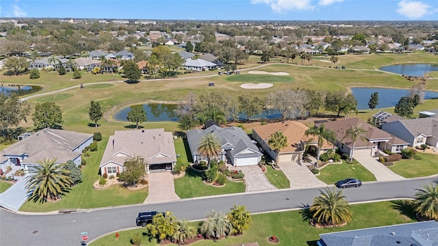 aerial view featuring a water view, view of golf course, and a residential view