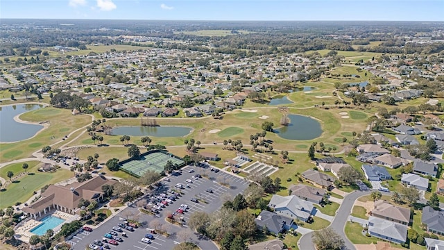 bird's eye view with golf course view, a water view, and a residential view