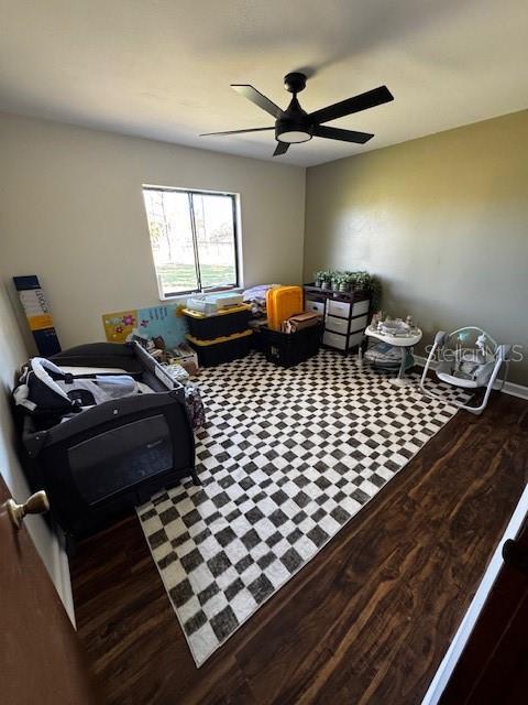 recreation room with a ceiling fan and wood finished floors