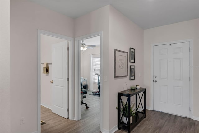 foyer entrance featuring wood finished floors and baseboards