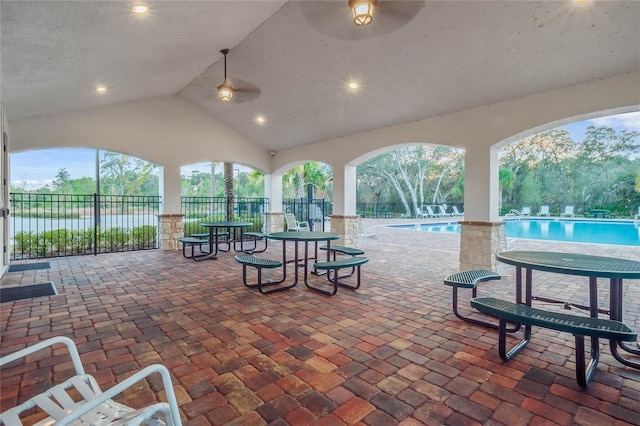 view of patio featuring a community pool and fence