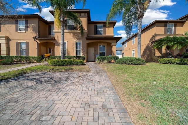 view of front of property with stucco siding and a front yard