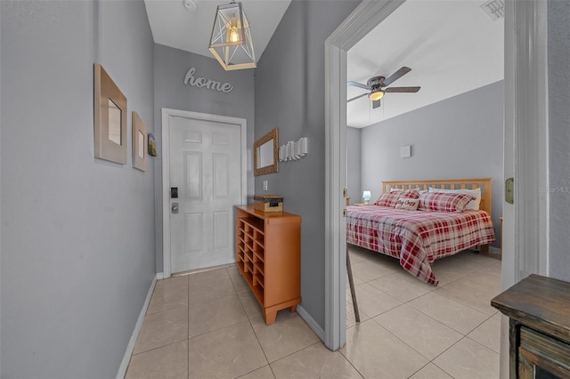 bedroom with visible vents, baseboards, light tile patterned flooring, and vaulted ceiling