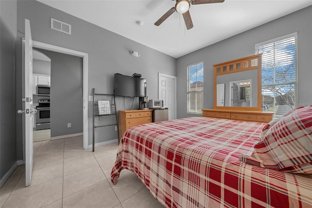 bedroom featuring multiple windows, baseboards, visible vents, and light tile patterned floors