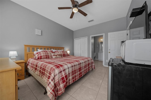 bedroom featuring light tile patterned floors, a ceiling fan, visible vents, and a closet