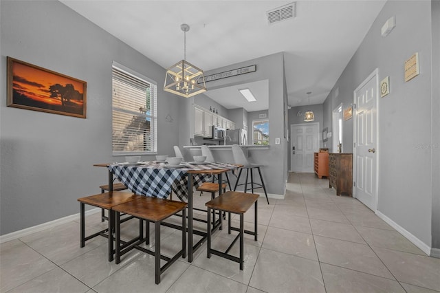 dining room with light tile patterned floors, visible vents, a chandelier, and baseboards