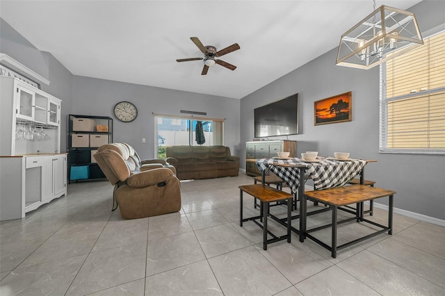 dining room featuring light tile patterned floors, a ceiling fan, and baseboards