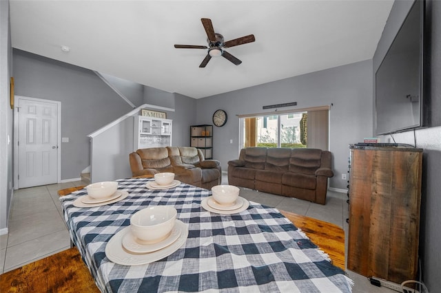 tiled bedroom with baseboards and a ceiling fan