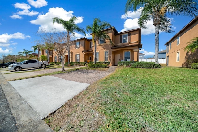 view of front of house with a front yard and stucco siding