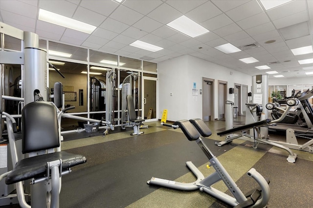 workout area with visible vents and a paneled ceiling