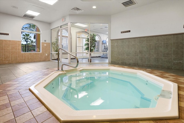 view of pool featuring a swimming pool and an indoor hot tub