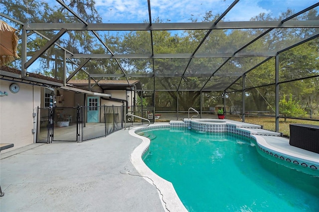 pool with a lanai, an in ground hot tub, and a patio