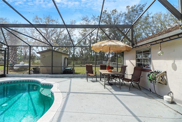 outdoor pool featuring a patio area and glass enclosure