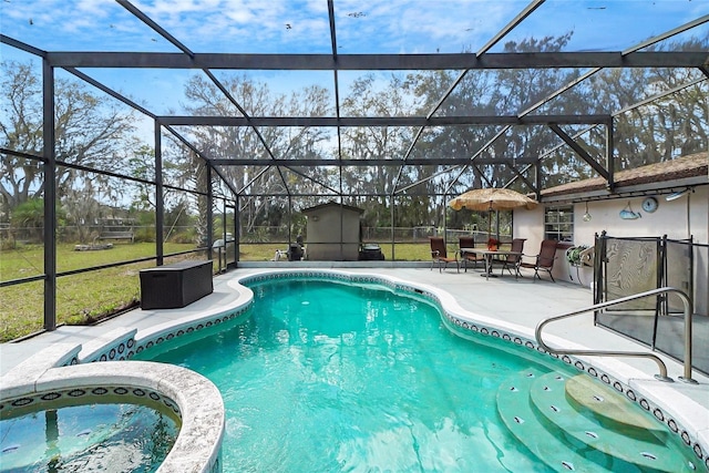 view of pool featuring a patio, an outdoor structure, a pool with connected hot tub, and glass enclosure