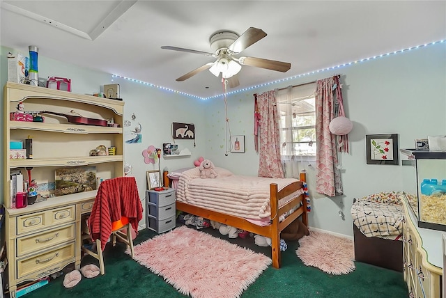 carpeted bedroom with ceiling fan and baseboards