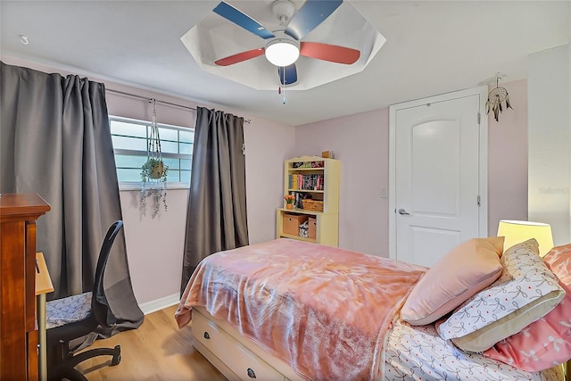 bedroom with a ceiling fan and wood finished floors