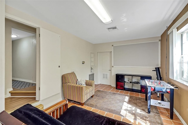 living area featuring visible vents, baseboards, and tile patterned floors