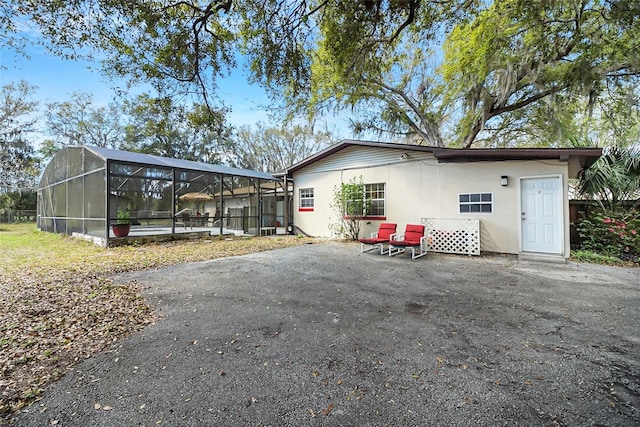 back of house featuring a patio area and a lanai