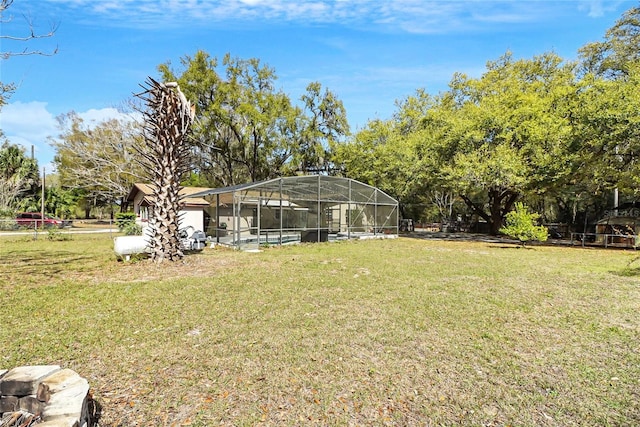 view of yard with glass enclosure