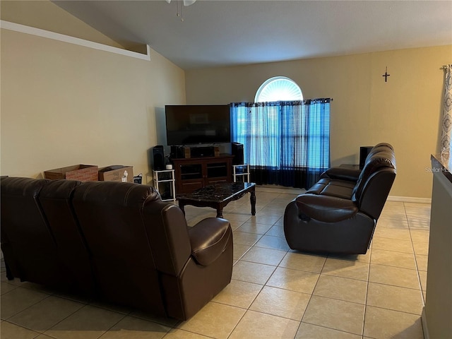 living room with light tile patterned floors, ceiling fan, and lofted ceiling