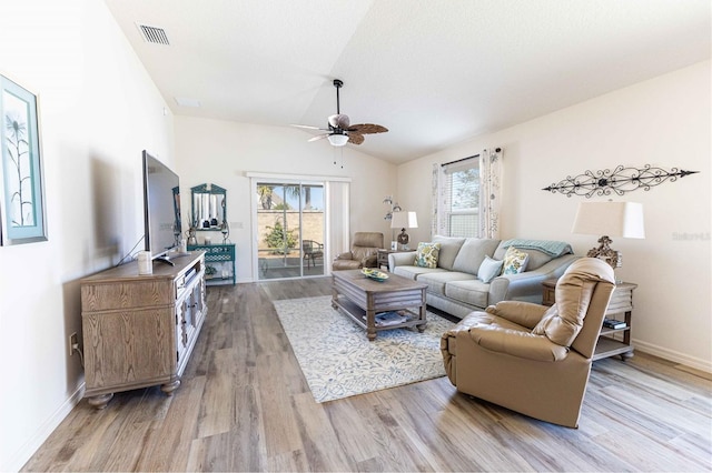 living room with visible vents, baseboards, ceiling fan, vaulted ceiling, and light wood-type flooring