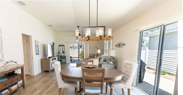 dining space with light wood-style flooring and visible vents