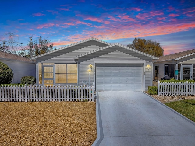 single story home with a garage, fence, and concrete driveway