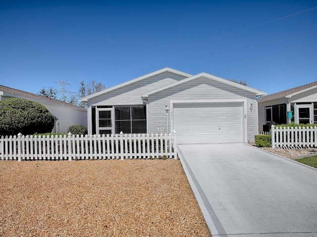 ranch-style house featuring a garage, fence, and driveway