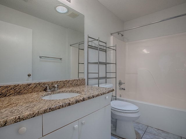 full bath featuring toilet, tub / shower combination, a textured ceiling, vanity, and tile patterned flooring