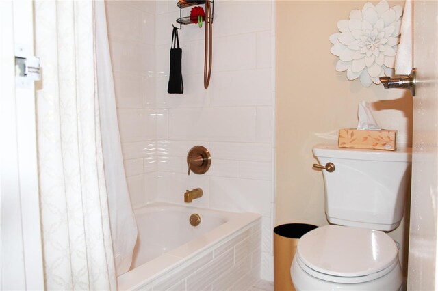 bathroom with shower / tub combo with curtain and toilet