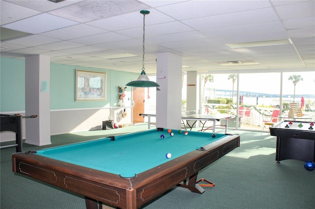 rec room with expansive windows, carpet flooring, and a paneled ceiling