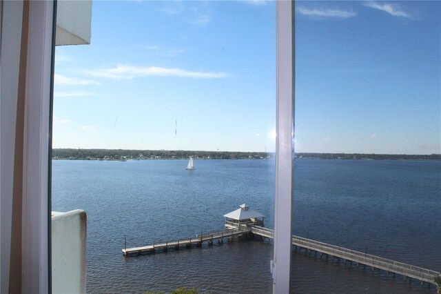 dock area with a water view and boat lift