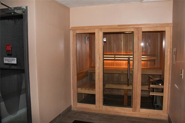 view of sauna / steam room featuring baseboards and wood finished floors