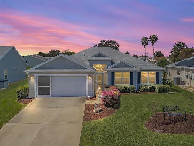 single story home featuring a garage, driveway, a front yard, and cooling unit