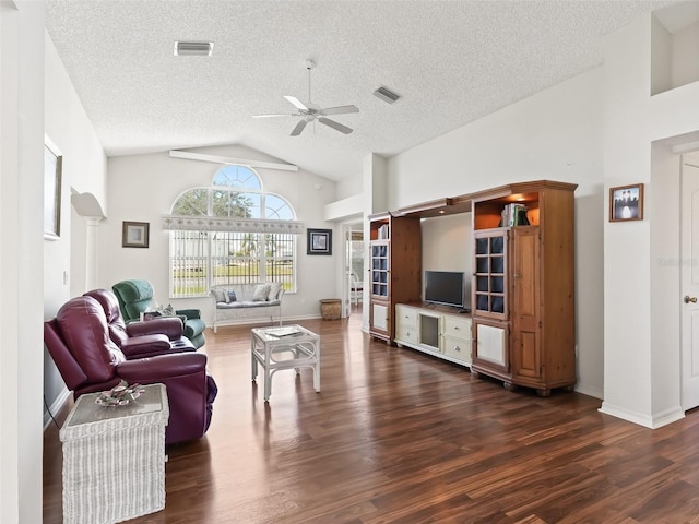 living area with ceiling fan, high vaulted ceiling, dark wood-type flooring, visible vents, and baseboards