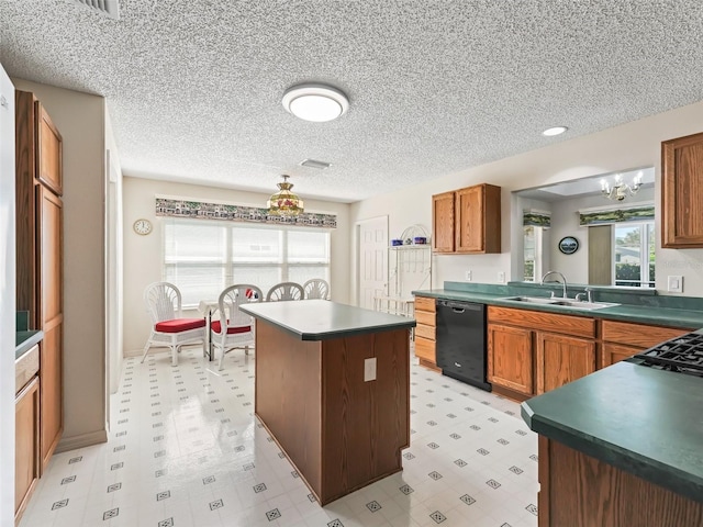 kitchen with black dishwasher, light floors, dark countertops, and a sink