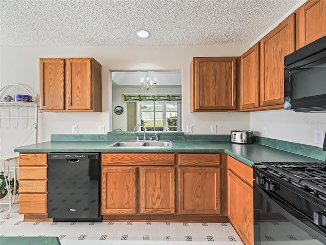 kitchen with a textured ceiling, a sink, brown cabinets, black appliances, and dark countertops