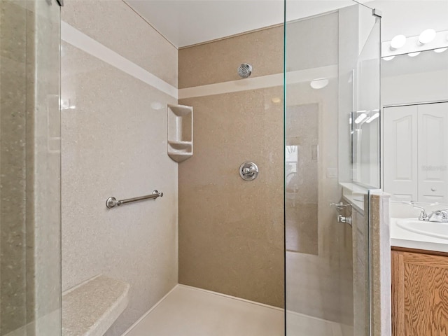 full bath with a walk in shower and vanity