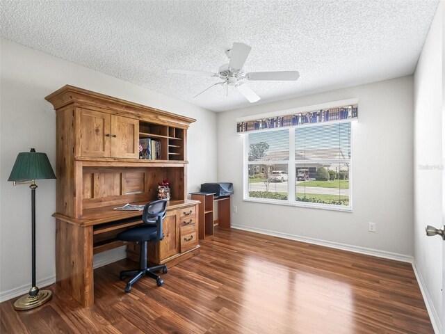 office featuring dark wood-style flooring, a textured ceiling, and baseboards