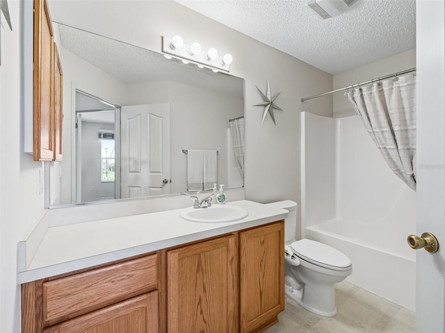 bathroom with a textured ceiling, toilet, vanity, and visible vents