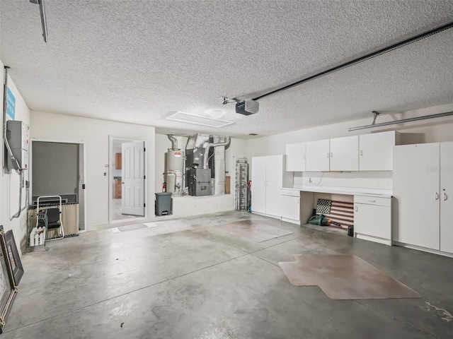 garage featuring water heater, a garage door opener, and heating unit