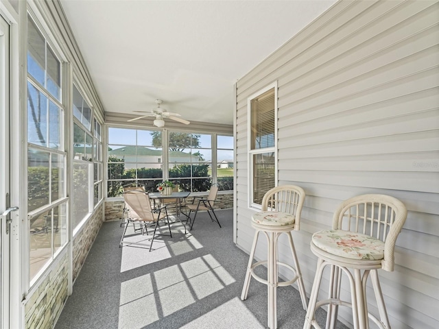 sunroom with a ceiling fan