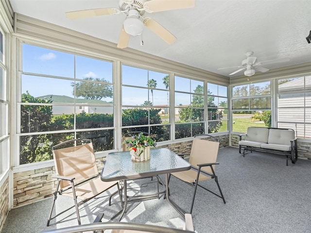 sunroom with a healthy amount of sunlight and ceiling fan